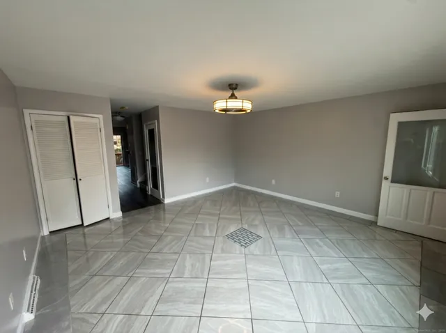 a view of an empty room with a bathroom