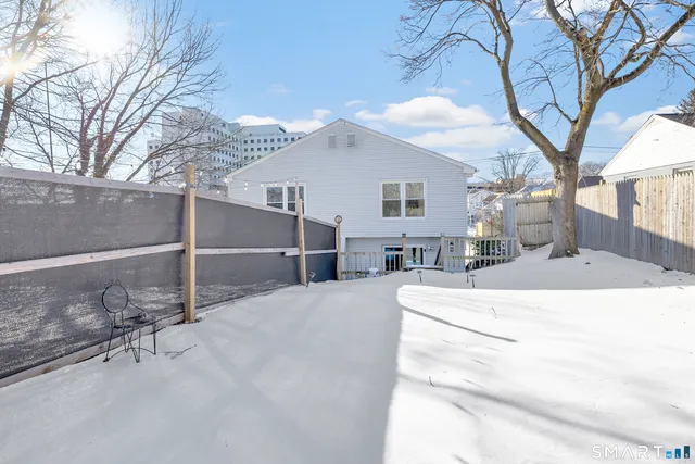 a view of a house with a wooden fence