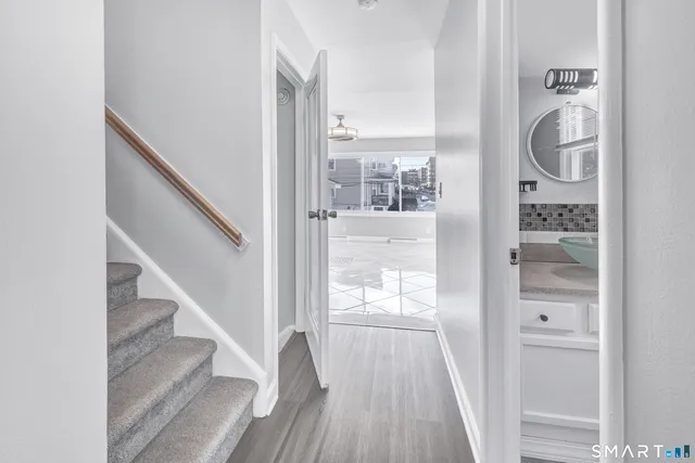 a view of a hallway with wooden floor and entryway