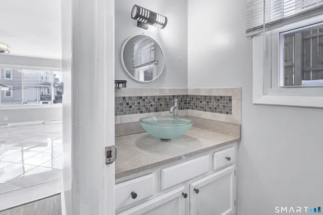 a view of bathroom with washing machine and mirror