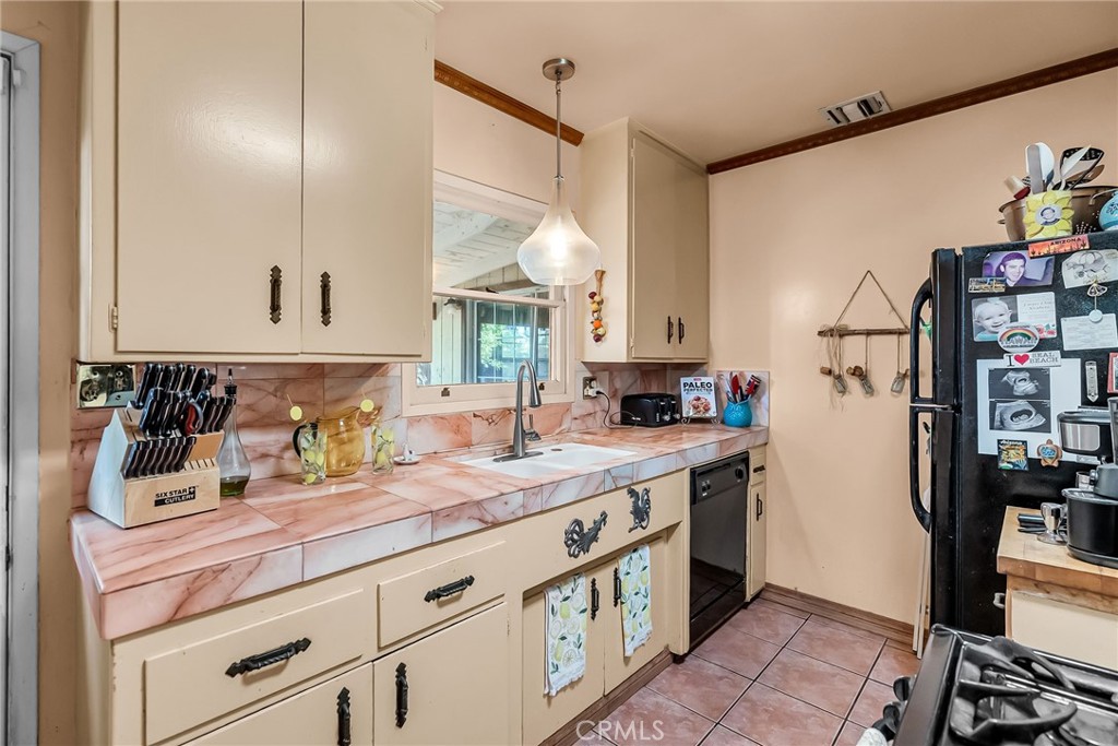 3085 Flanders Road Riverside, CA 92507 - Photo 12 of 23 a kitchen with a sink dishwasher a refrigerator and cabinets