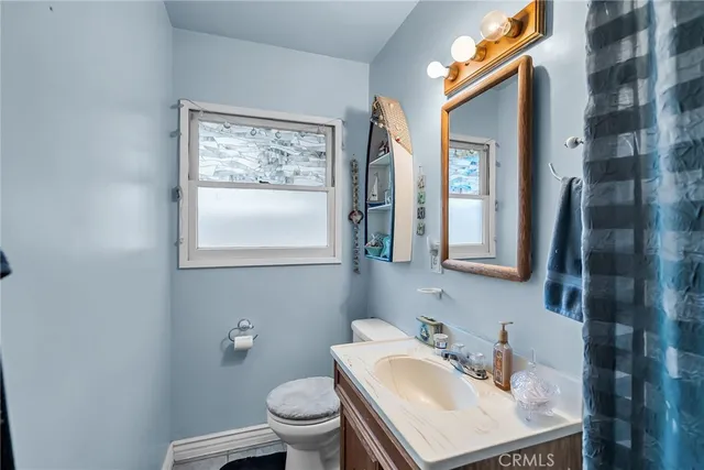 a bathroom with a sink mirror and toilet