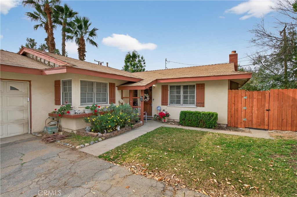 3085 Flanders Road Riverside, CA 92507 - Photo 22 of 23 a front view of house with yard and green space
