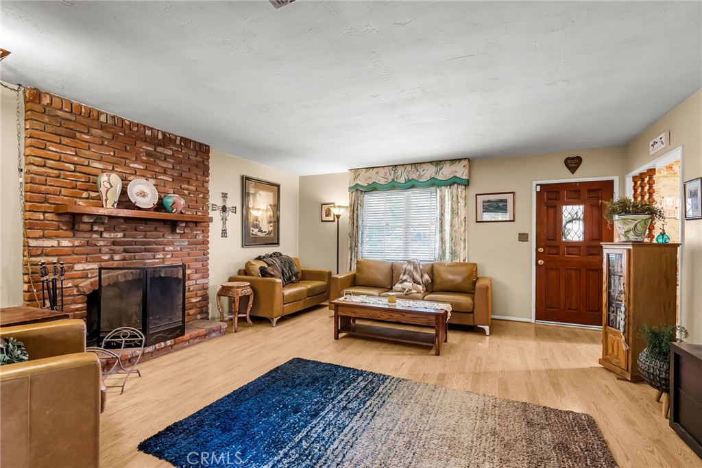 3085 Flanders Road Riverside, CA 92507 - Photo 4 of 23 a living room with furniture flat screen tv and a fireplace