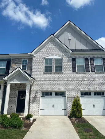 a front view of a house with garage