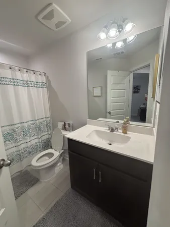 a bathroom with a sink double vanity granite and a mirror