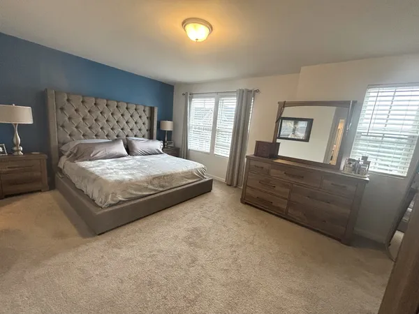a spacious bedroom with a large bed and a couch