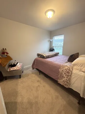 a bedroom with a bed and a table