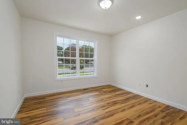 a view of room with wooden floor