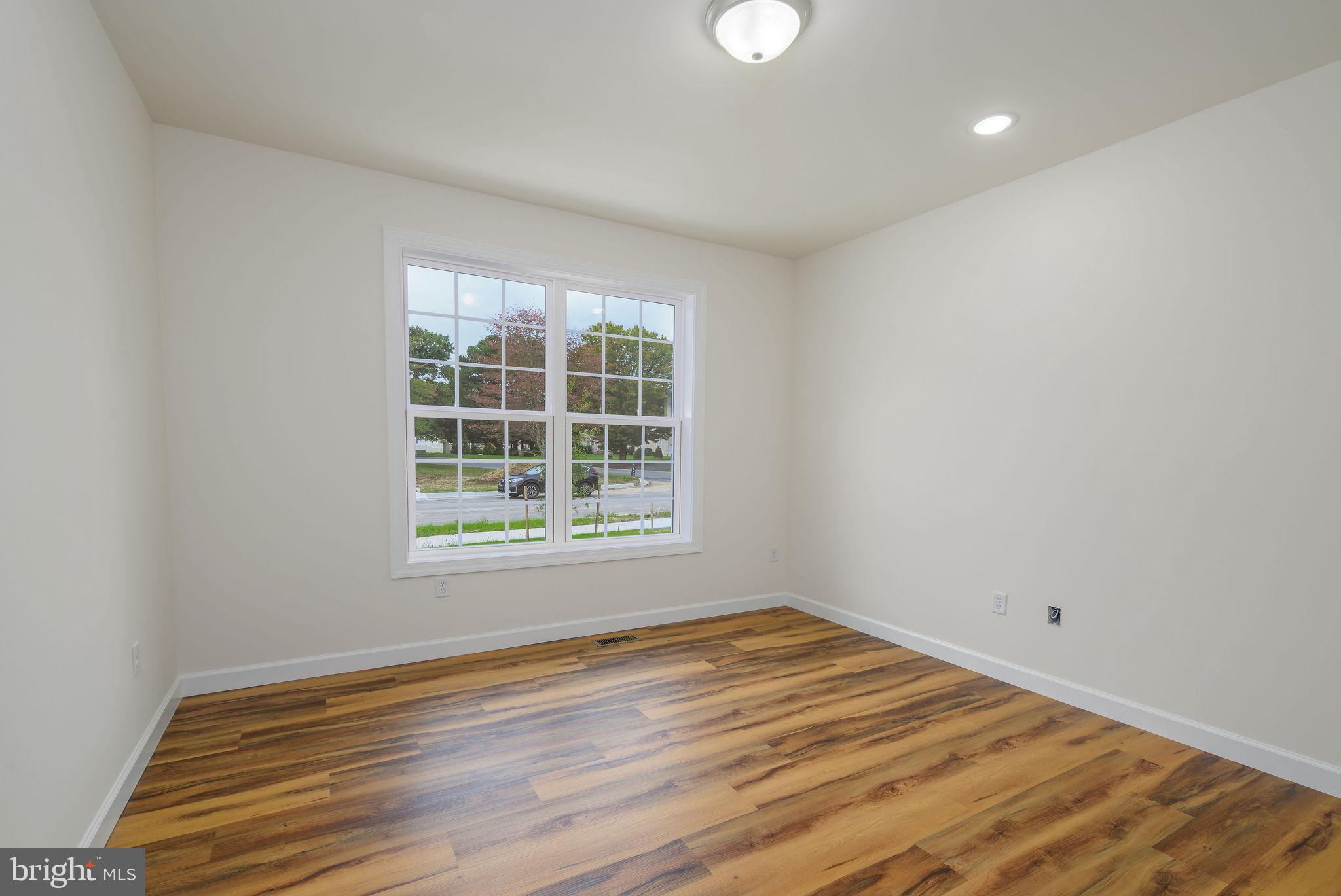 3 Valhalla Court Dover, DE 19904 - Photo 16 of 57 an empty room with wooden floor and windows