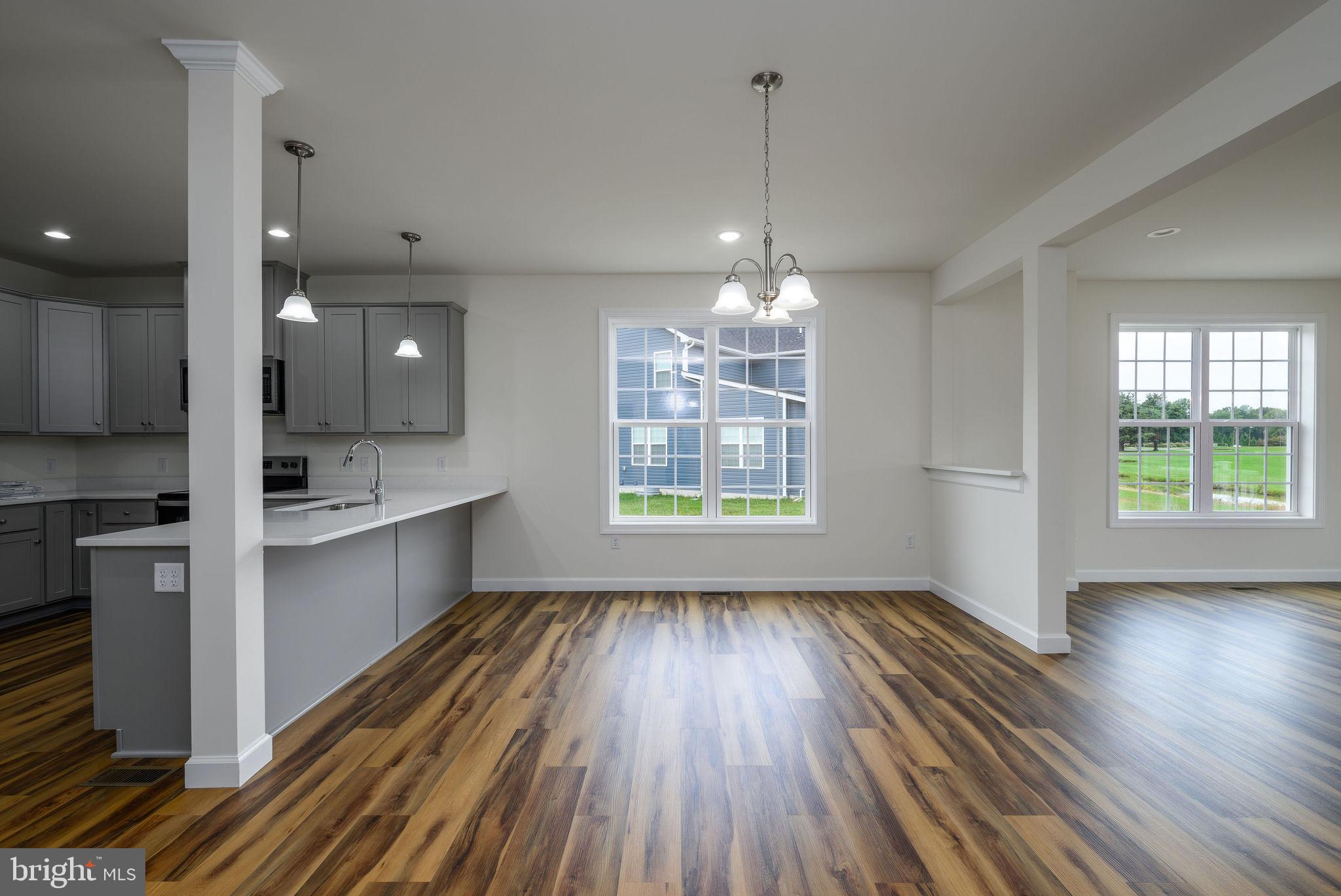 3 Valhalla Court Dover, DE 19904 - Photo 24 of 57 a large kitchen with kitchen island white cabinets and wooden floor