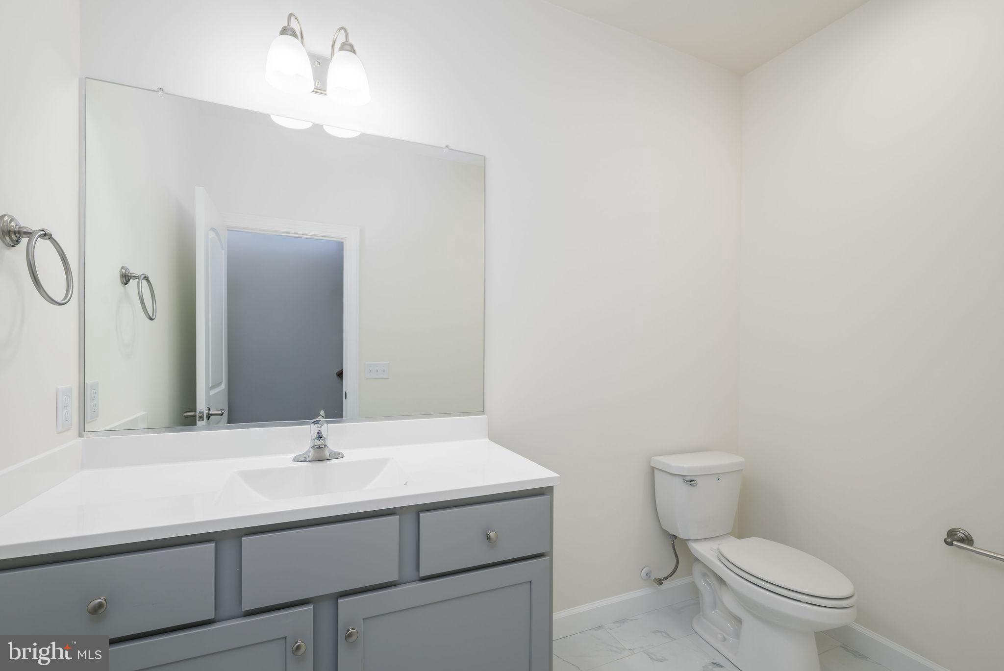 3 Valhalla Court Dover, DE 19904 - Photo 37 of 57 a bathroom with a sink toilet and mirror