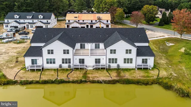 a view of a house with pool and chairs