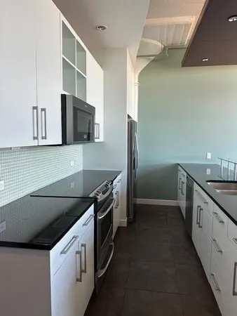 a view of water heater room with wooden floor