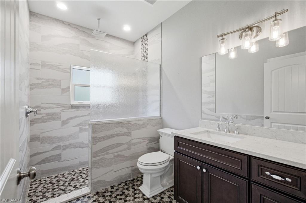 2053 17th Street Southwest Naples, FL 34117 - Photo 32 of 47 a bathroom with a sink a toilet and shower
