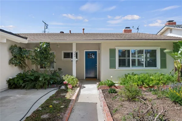 a view of a house with potted plants