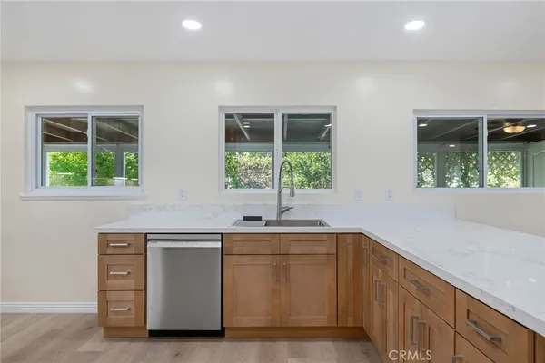 a kitchen with a sink and large window