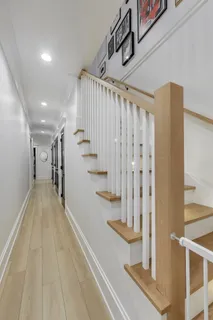 a view of entryway and hall with wooden floor