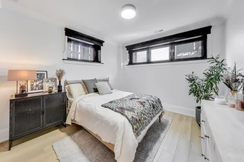 a spacious bedroom with a large bed and a potted plant