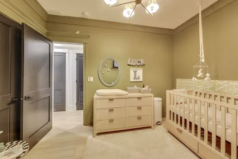 a bedroom with furniture and a baby crib