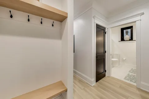 a view of a hallway with wooden floor and staircase