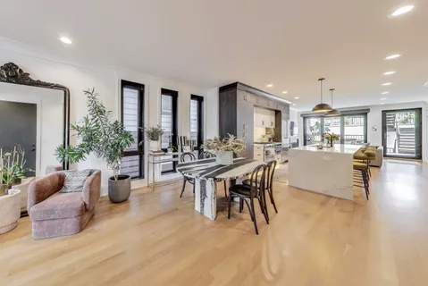 a dining room with furniture and wooden floor