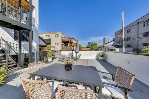 a view of an outside dining space with seating
