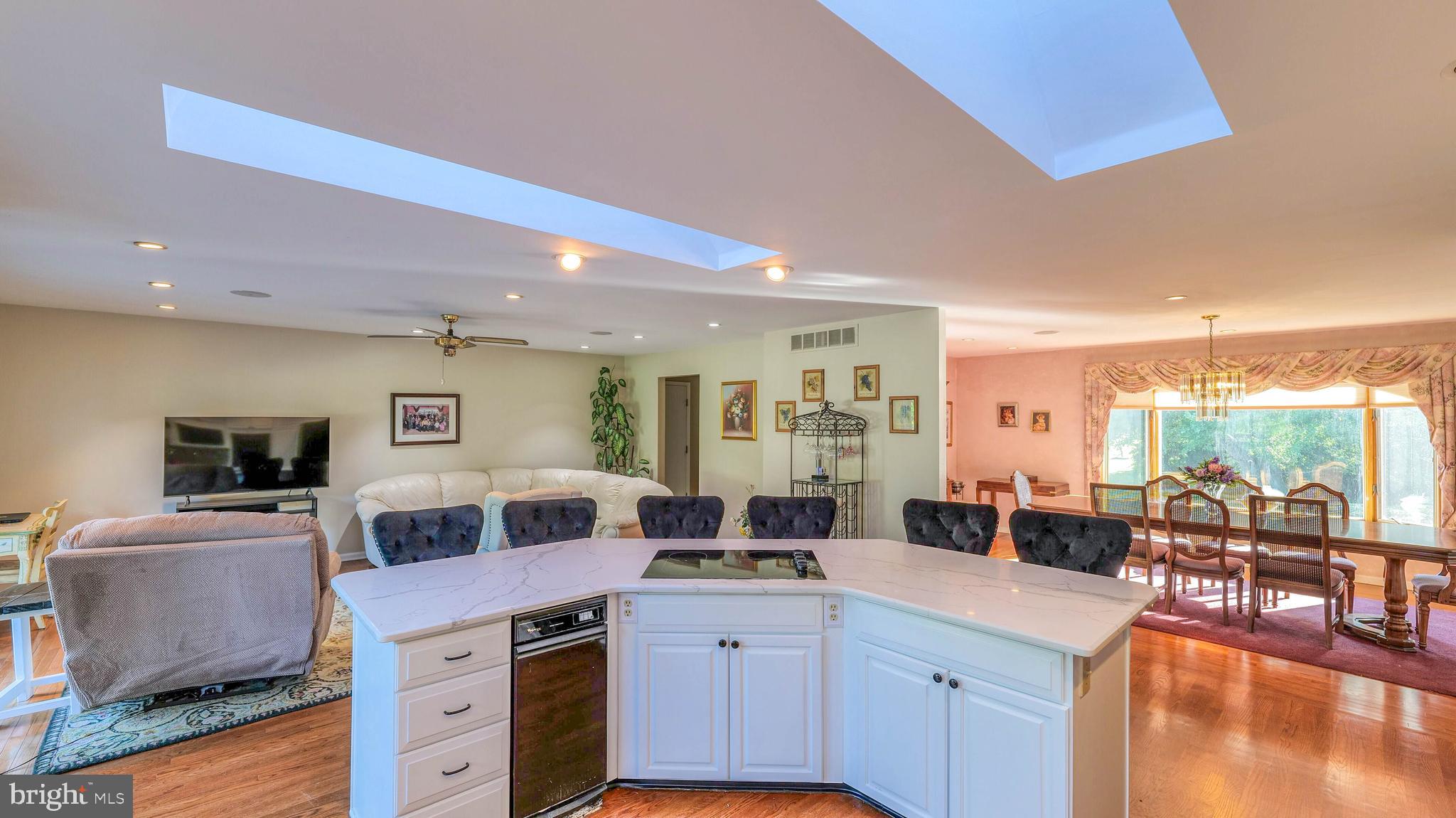 272 Hartford Road Medford, NJ 08055 - Photo 15 of 37 a living room with stainless steel appliances kitchen island granite countertop a table and chairs in it