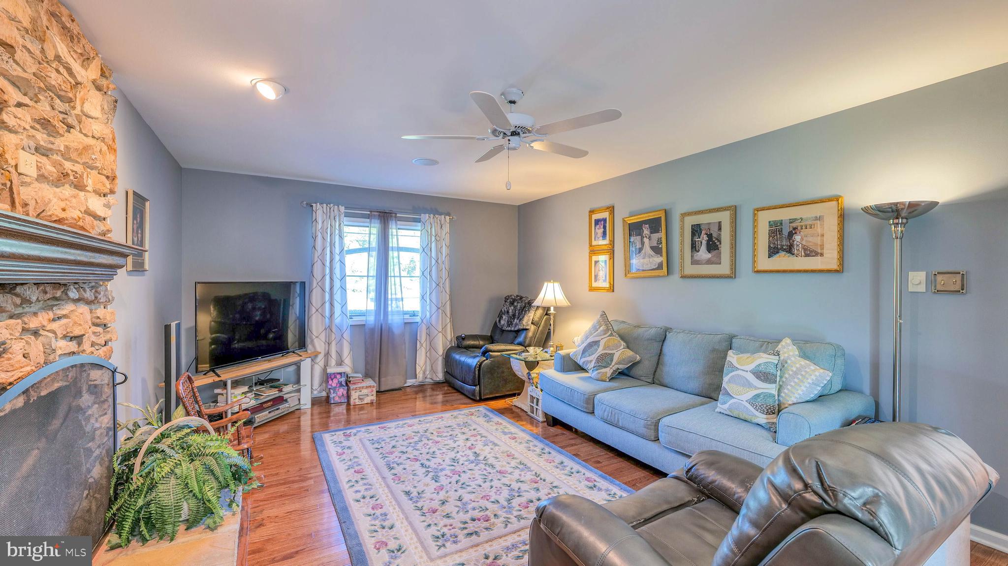 272 Hartford Road Medford, NJ 08055 - Photo 19 of 37 a living room with furniture a flat screen tv and a fireplace