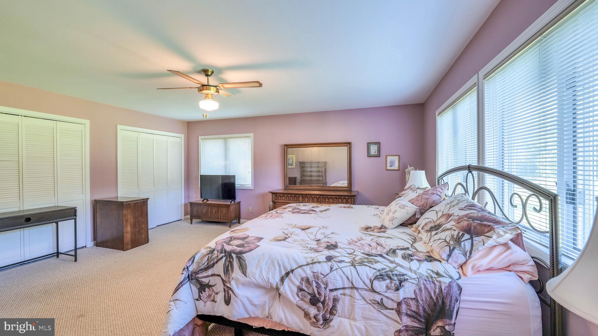 272 Hartford Road Medford, NJ 08055 - Photo 27 of 37 a bedroom with a large bed a chandelier and dresser