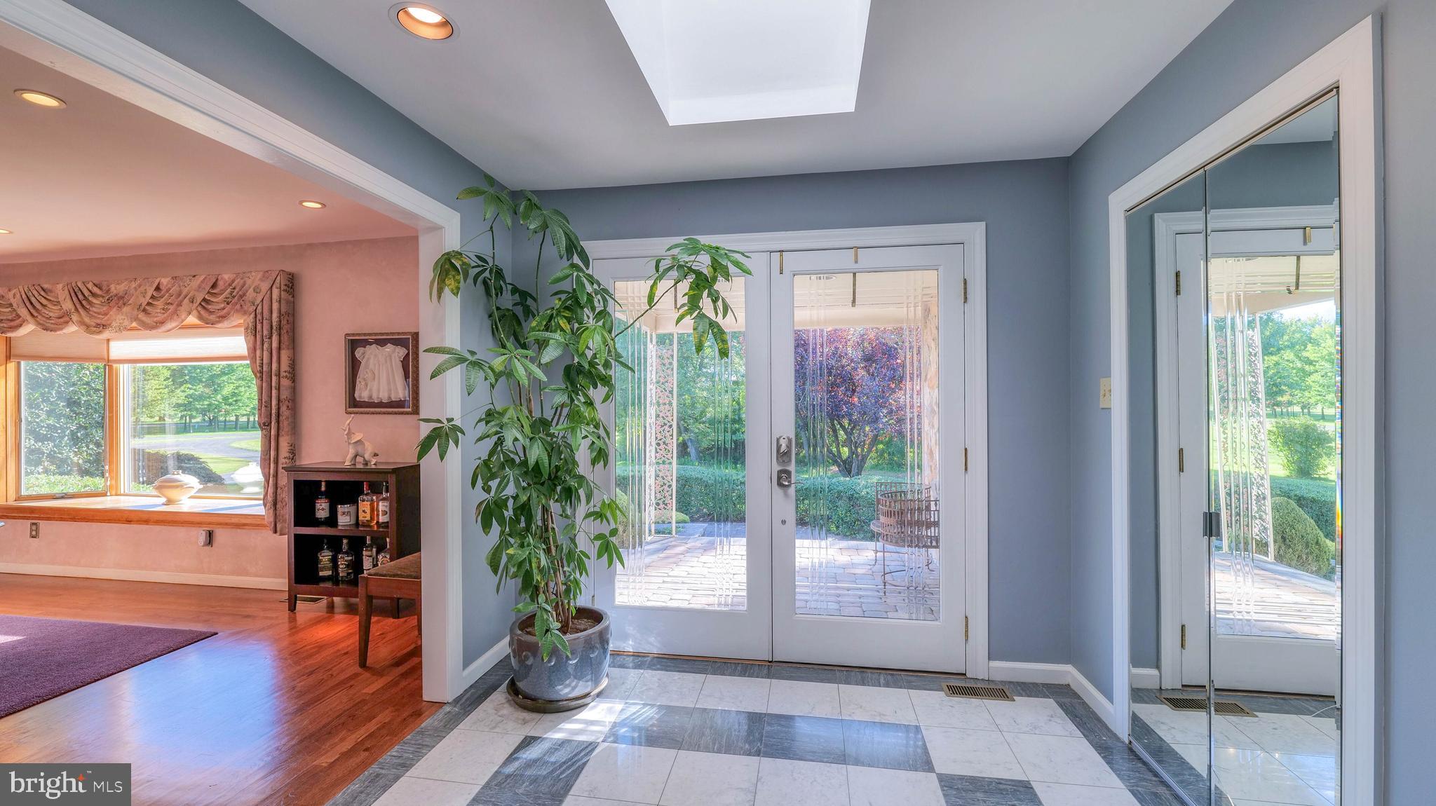 272 Hartford Road Medford, NJ 08055 - Photo 8 of 37 a view of an entryway with a floor to ceiling window and wooden floor
