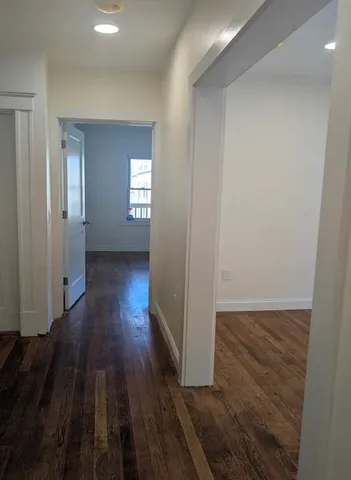 a view of wooden floor and windows in a room