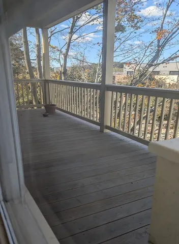 a view of a balcony with wooden floor