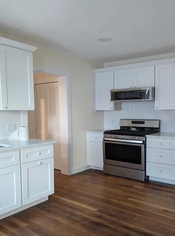 a kitchen with a stove and a microwave