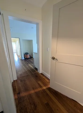 a view of a room with wooden floor