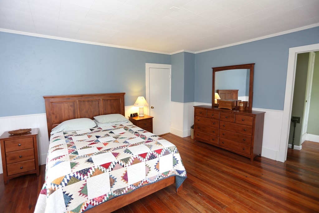 118 Bourne Street Three Rivers, MA 01080 - Photo 13 of 30 a bedroom with a bed and wooden floor