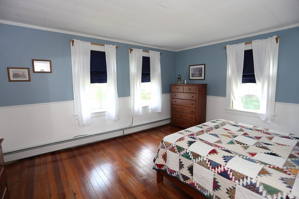 118 Bourne Street Three Rivers, MA 01080 - Photo 14 of 30 a bedroom with a bed and wooden floor