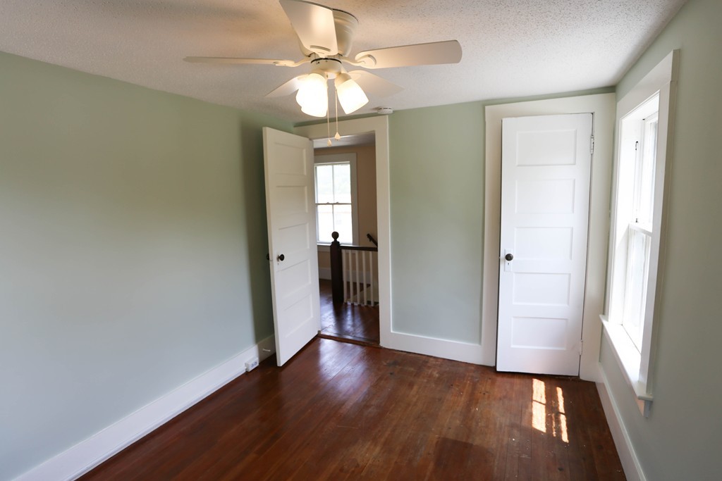 118 Bourne Street Three Rivers, MA 01080 - Photo 25 of 30 an empty room with wooden floor and windows