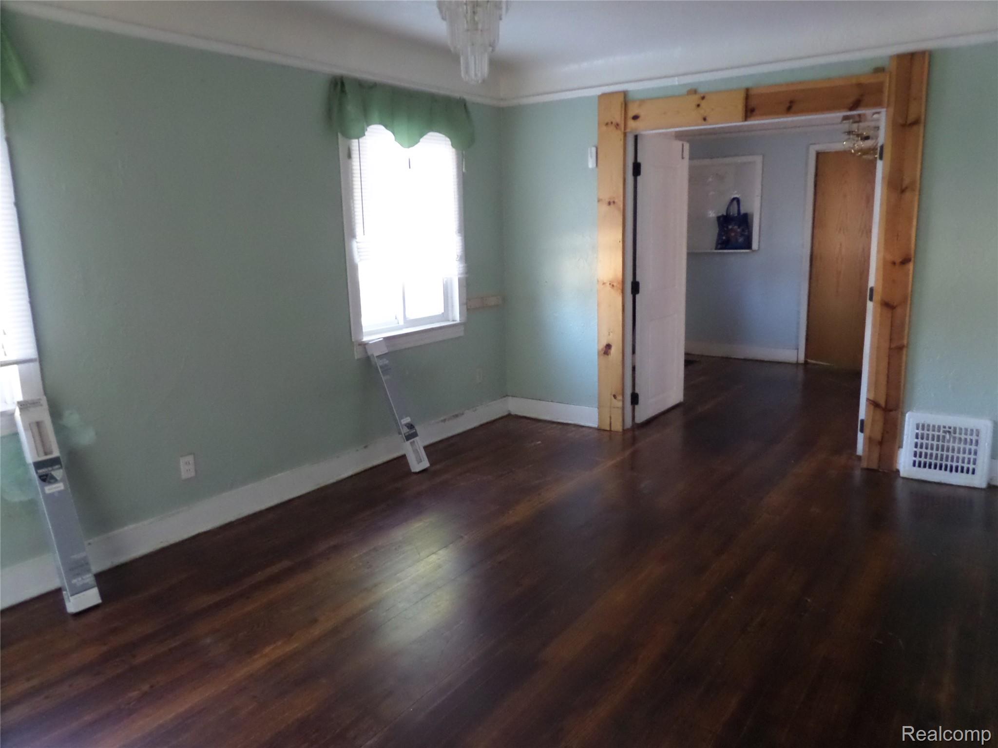 384 Perry Street Pontiac, MI 48342 - Photo 9 of 28 Unit 2 Empty room featuring dark wood-style flooring and baseboards