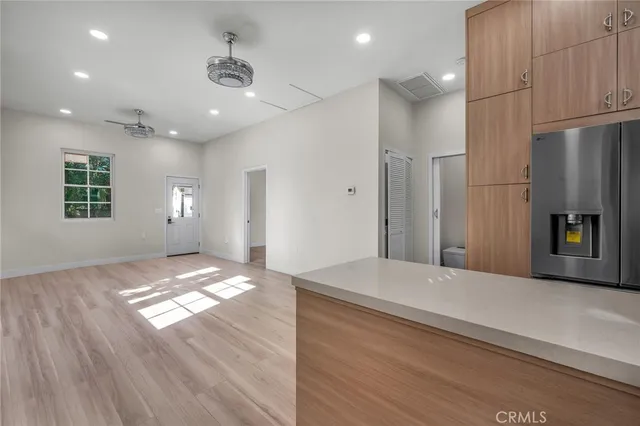 a view of empty room with wooden floor and window