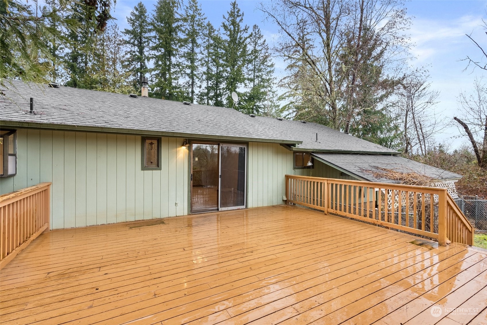 684 Nevil Road Winlock, WA 98596 - Photo 20 of 26 a view of a house with a wooden deck