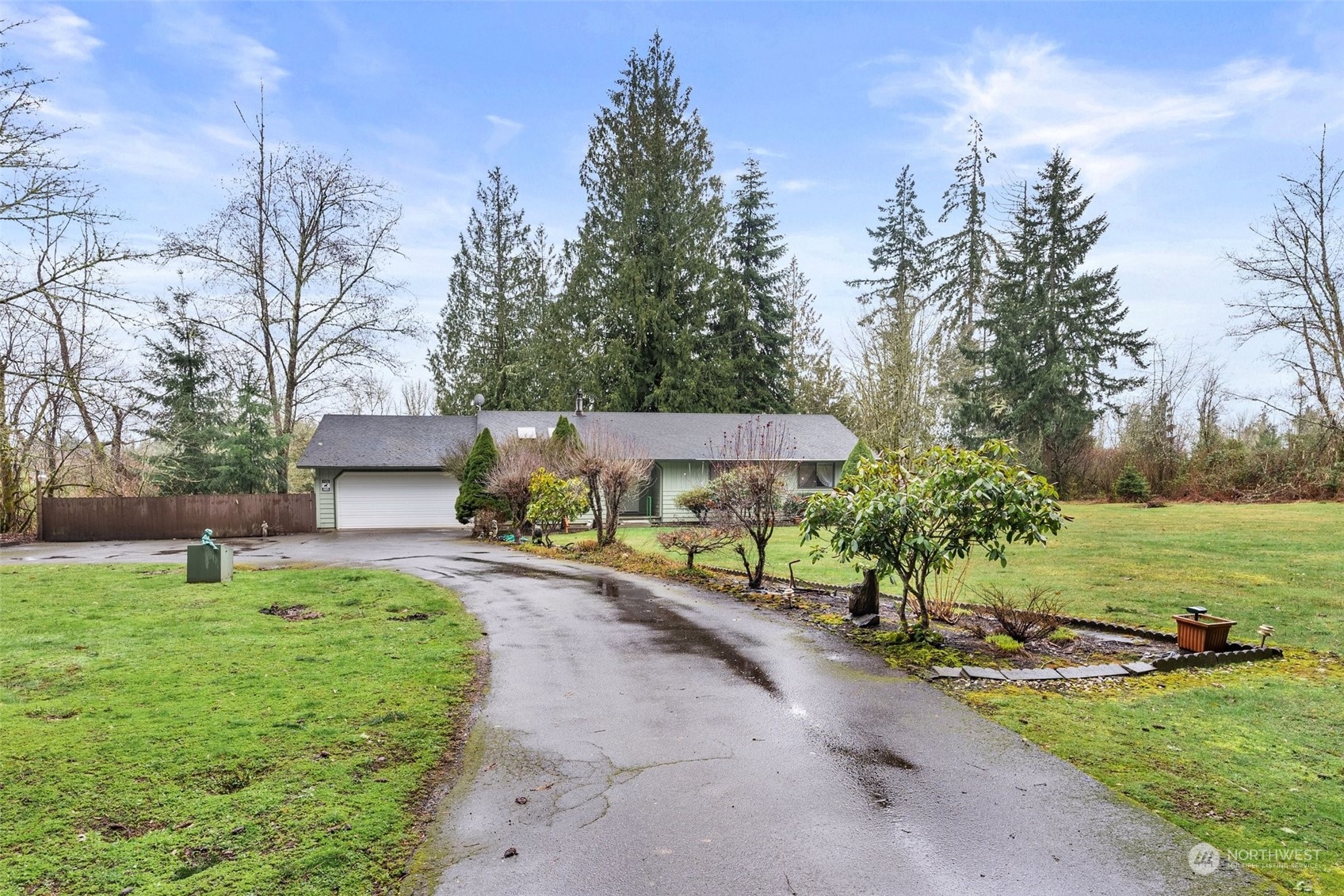 684 Nevil Road Winlock, WA 98596 - Photo 2 of 26 a front view of a house with a yard and trees