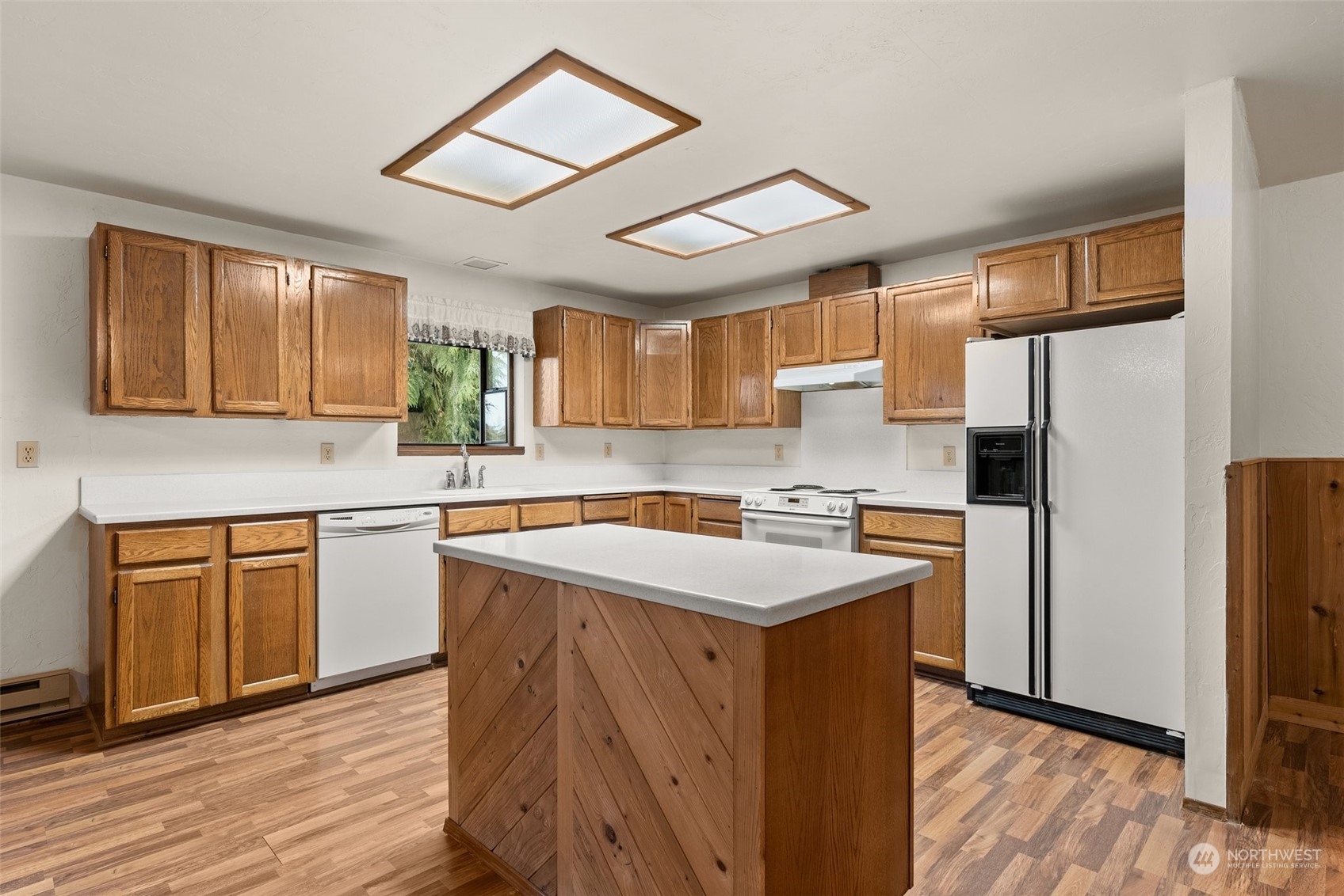 684 Nevil Road Winlock, WA 98596 - Photo 8 of 26 a kitchen with stainless steel appliances granite countertop a refrigerator a sink dishwasher a stove with wooden cabinets and wooden floor