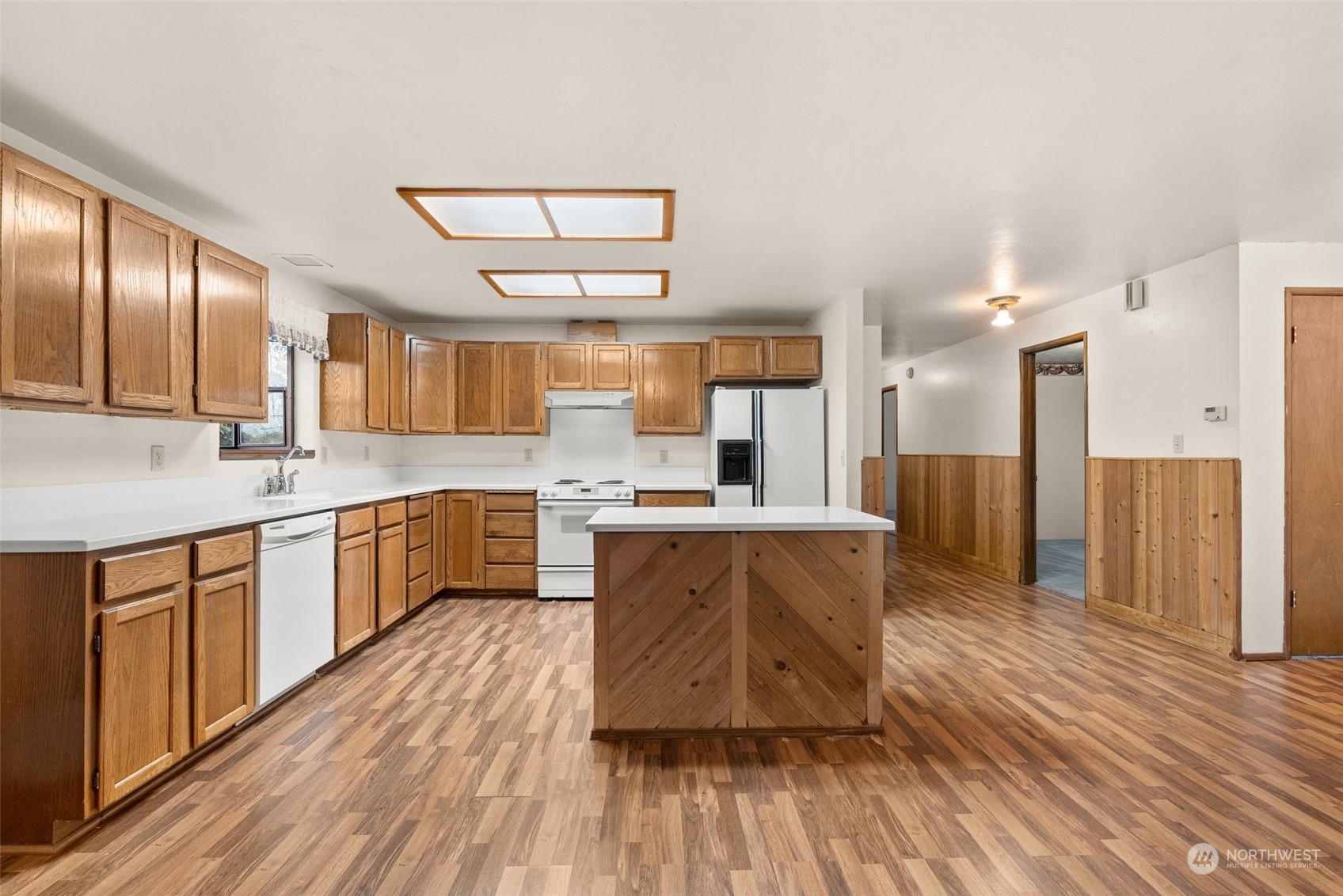 684 Nevil Road Winlock, WA 98596 - Photo 9 of 26 a large kitchen with stainless steel appliances a large counter top a sink a stove and a refrigerator