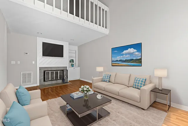 a living room with furniture a rug and a flat screen tv