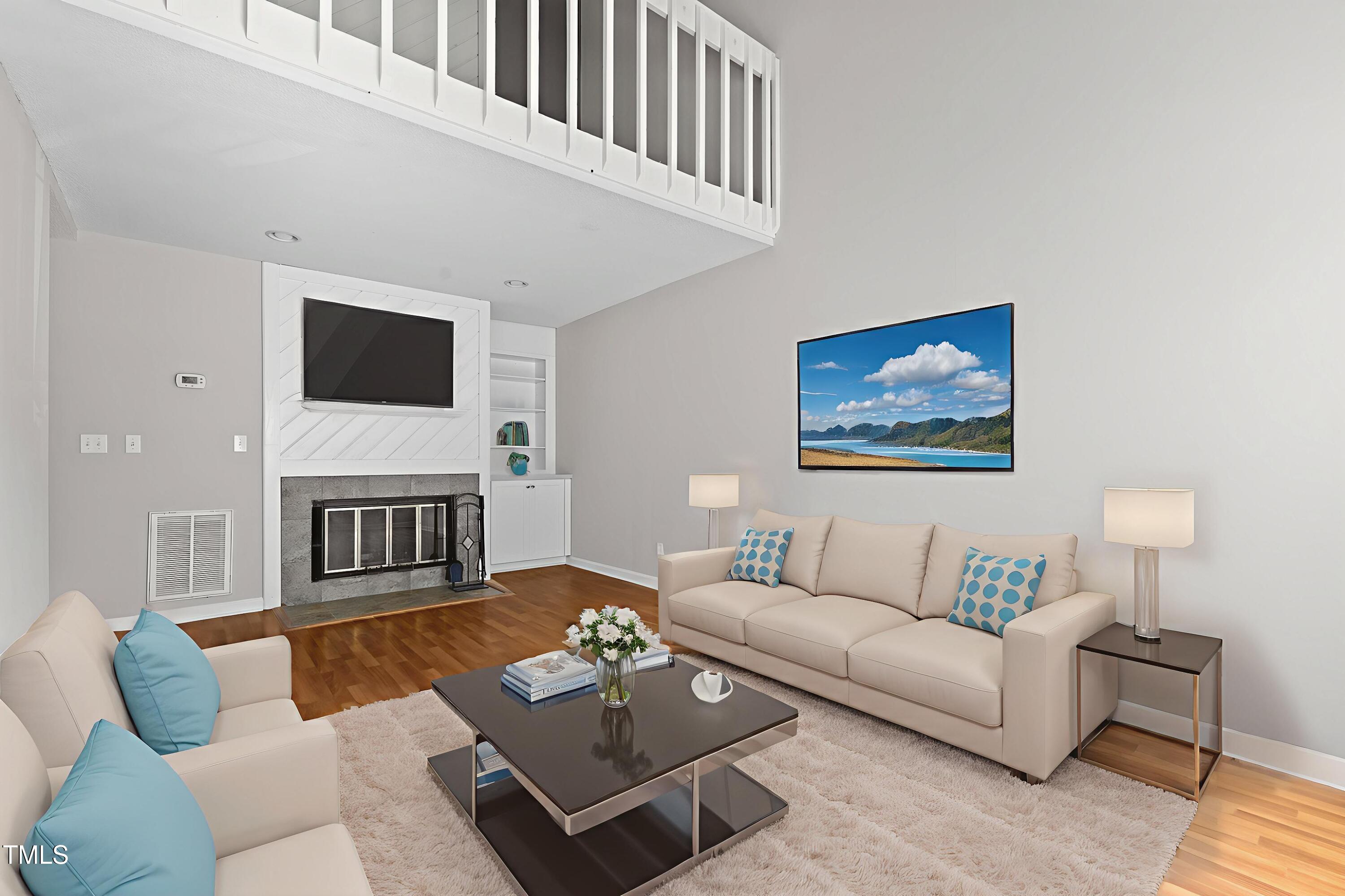 a living room with furniture a rug and a flat screen tv