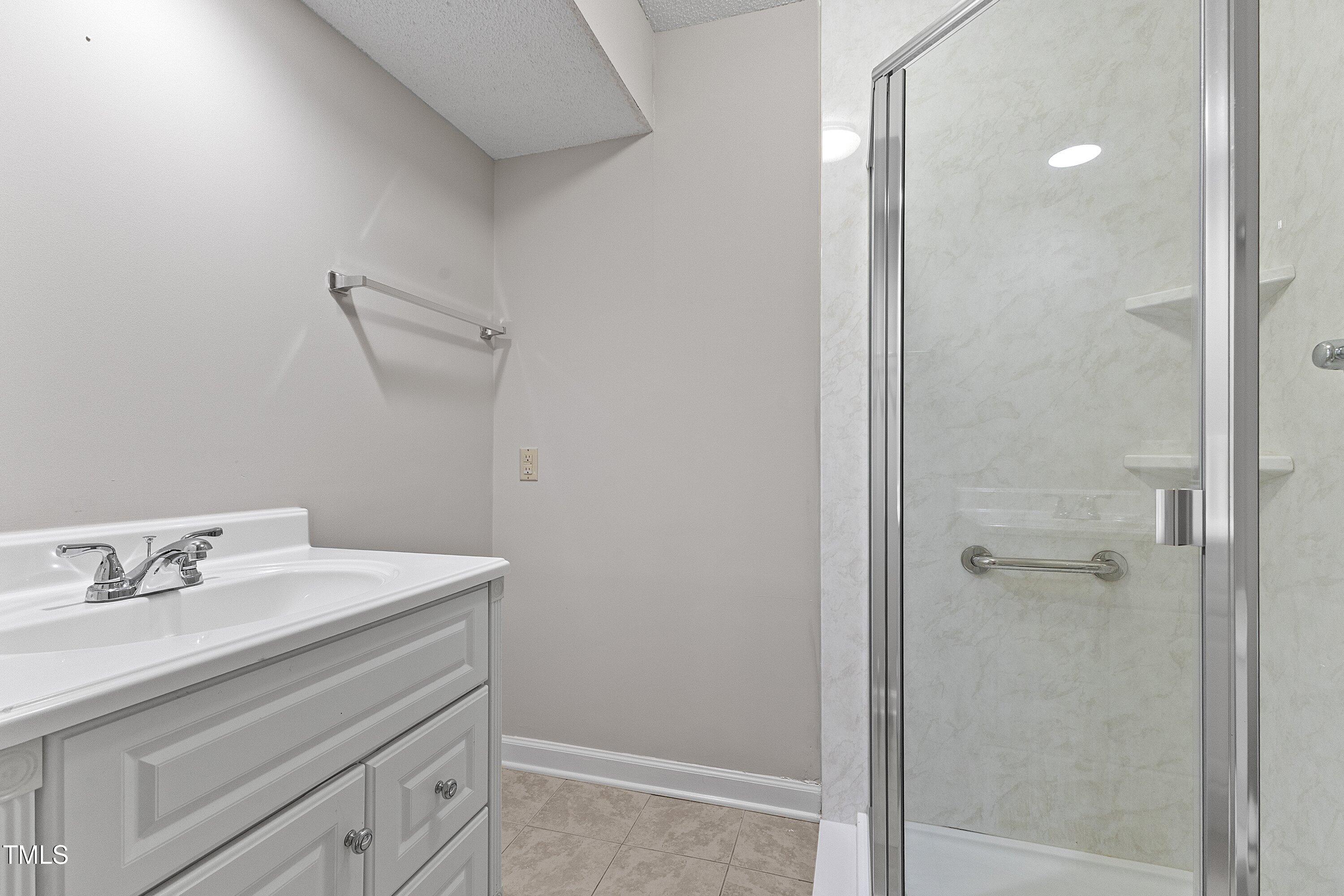 4350 Hunters Club Drive Raleigh, NC 27606 - Photo 14 of 33 a bathroom with a sink and a mirror