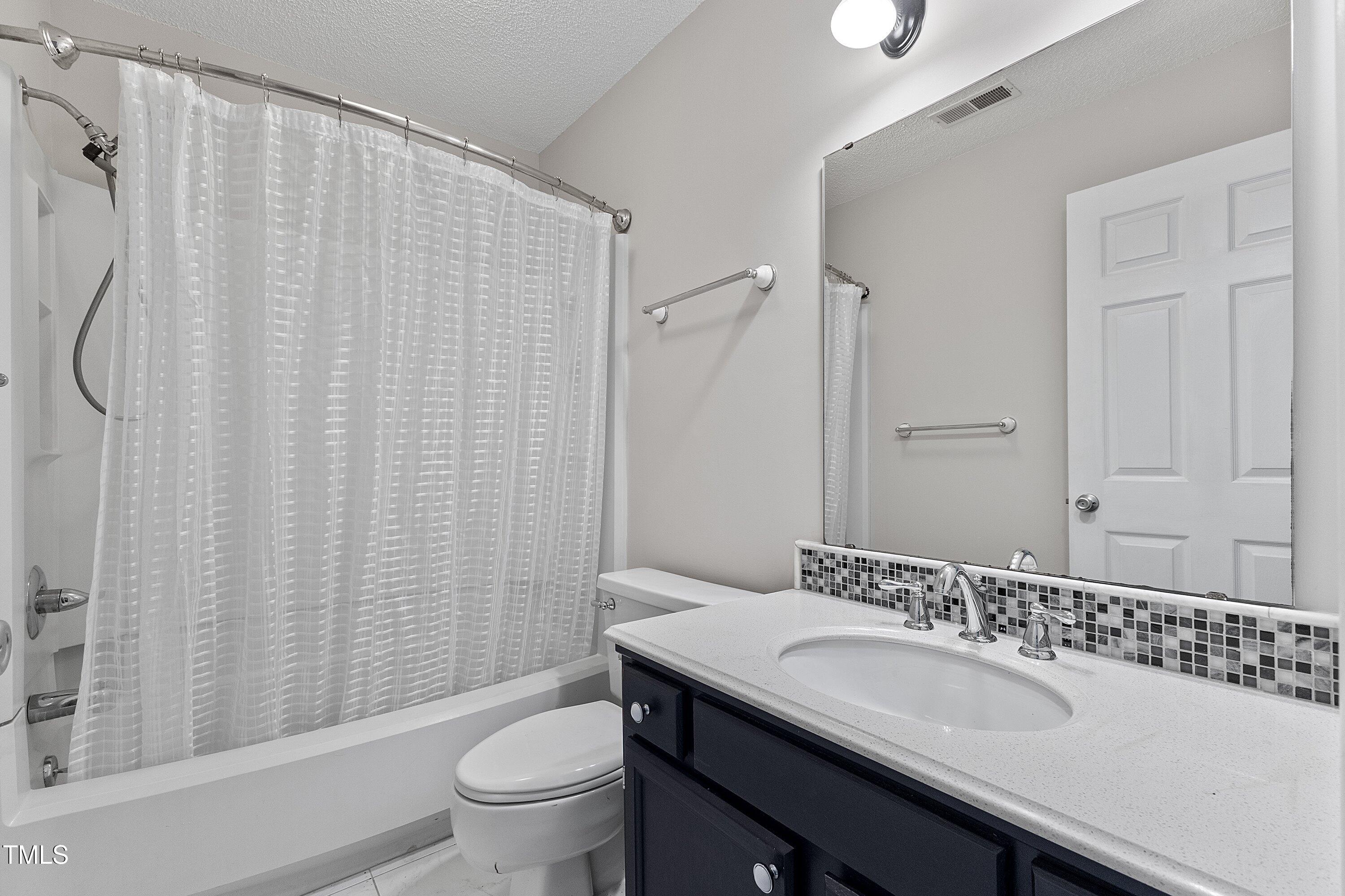 4350 Hunters Club Drive Raleigh, NC 27606 - Photo 17 of 33 a bathroom with a sink and a mirror