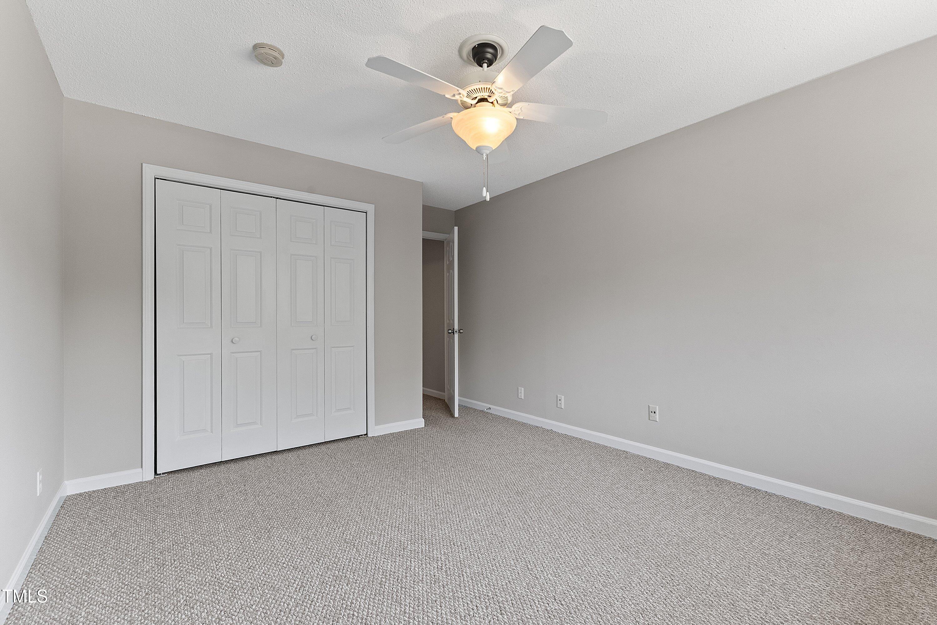 4350 Hunters Club Drive Raleigh, NC 27606 - Photo 19 of 33 an empty room with chandelier fan and window