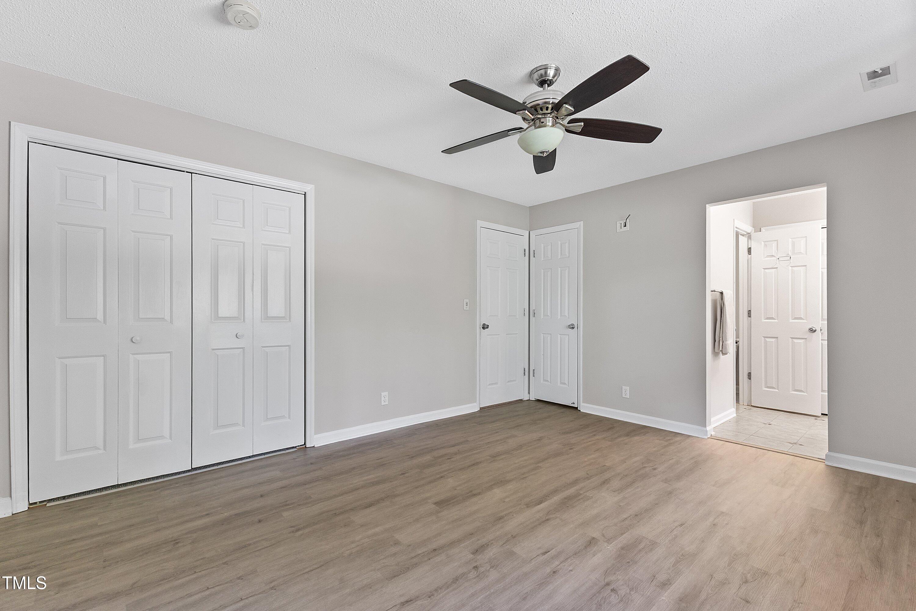 4350 Hunters Club Drive Raleigh, NC 27606 - Photo 21 of 33 a view of a big room with wooden floor and windows